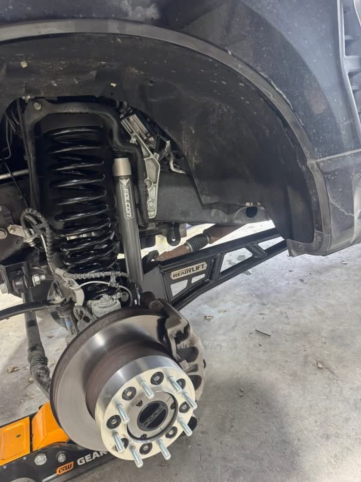 Falcon shock and ReadyLift suspension install in progress at Elite Custom Automotive in Lockport, LA