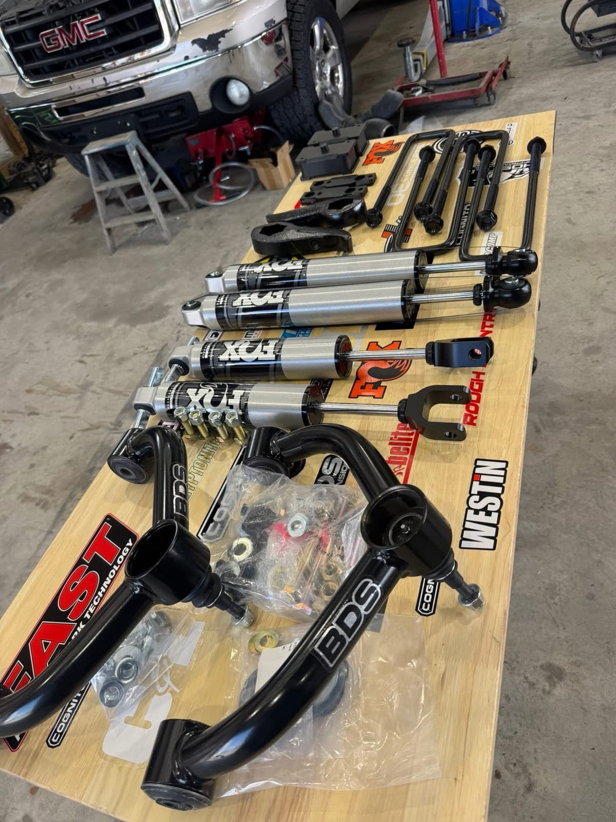BDS, Cognito, Fox, and Rough Country suspension parts on the workbench at Elite Custom Automotive in Lockport, LA
