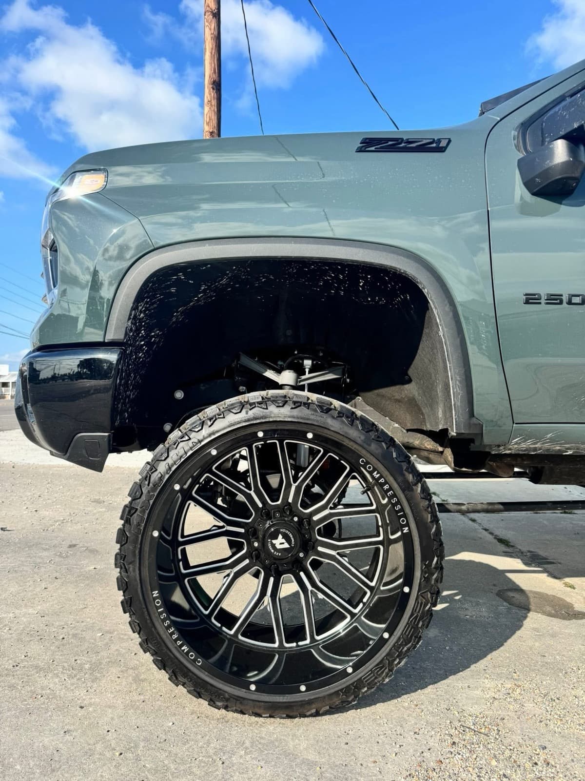 Custom black multi-spoke wheel on a lifted Chevrolet 2500HD Z71 by Elite Custom Automotive in Lockport, LA